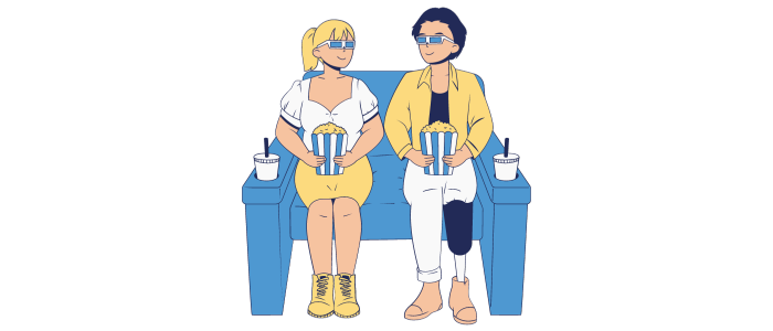 Una mujer y un hombre con gafas 3D y palomitas, sentados en una butaca de cine. 